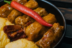  Mixed minced meat rolled in cabbage with polenta, sour cream and a chilli pepper on the side
